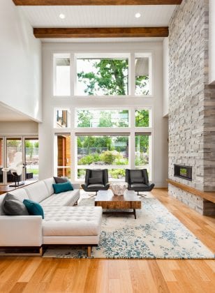 open_living_room_white_blue_accent_stone_fireplace_woodfloors_modern